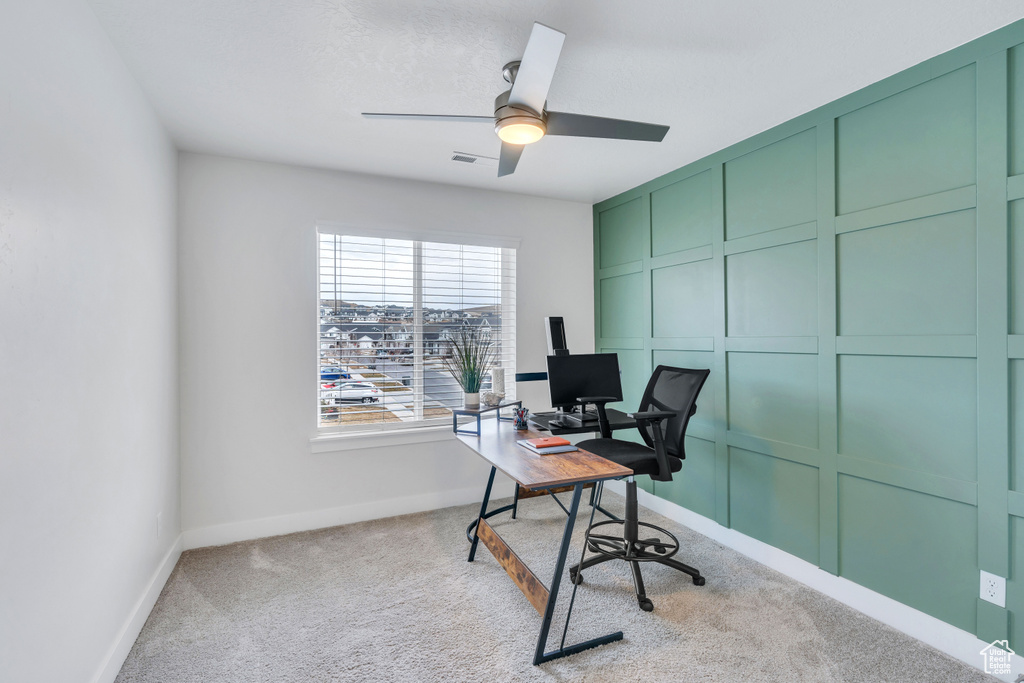 Carpeted office space with ceiling fan