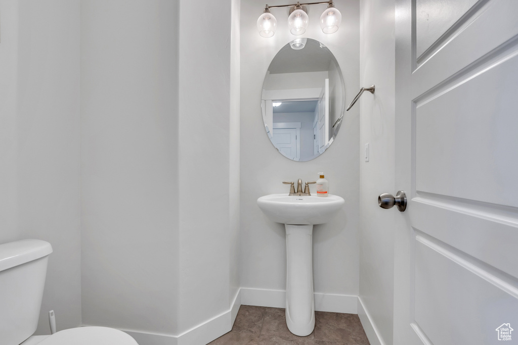 Bathroom with tile patterned floors and toilet