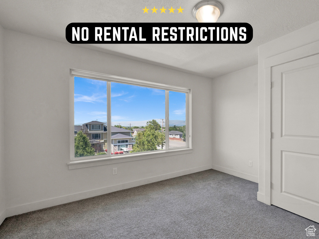 Spare room with carpet floors and baseboards