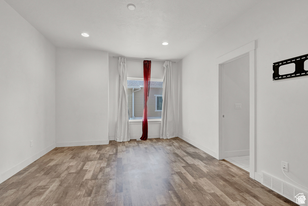 Spare room featuring wood finished floors and recessed lighting