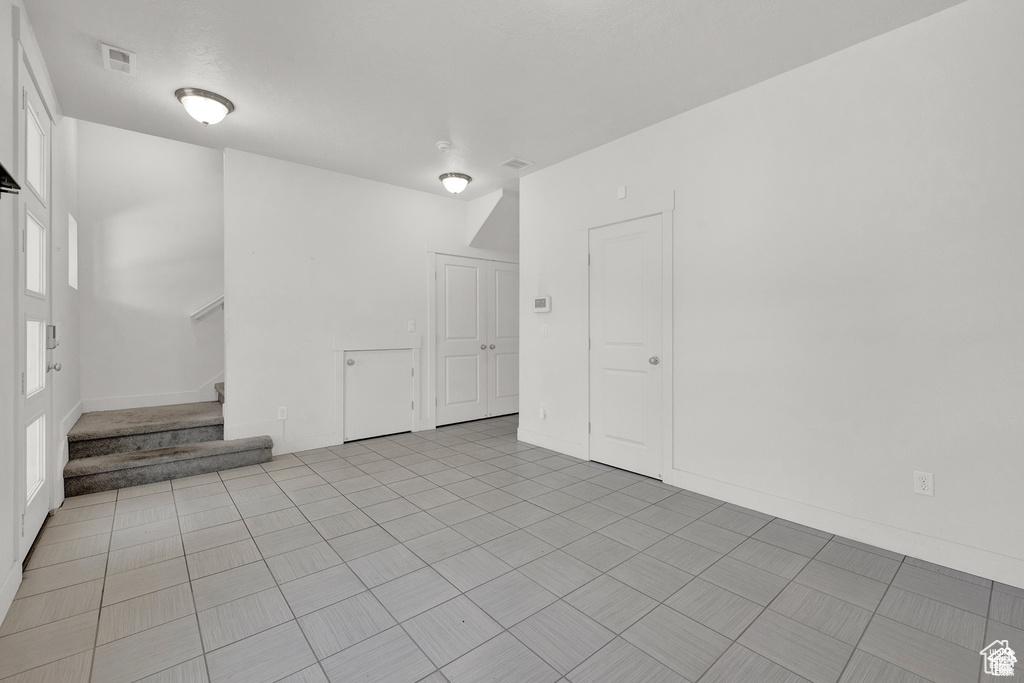 Empty room with stairs and baseboards