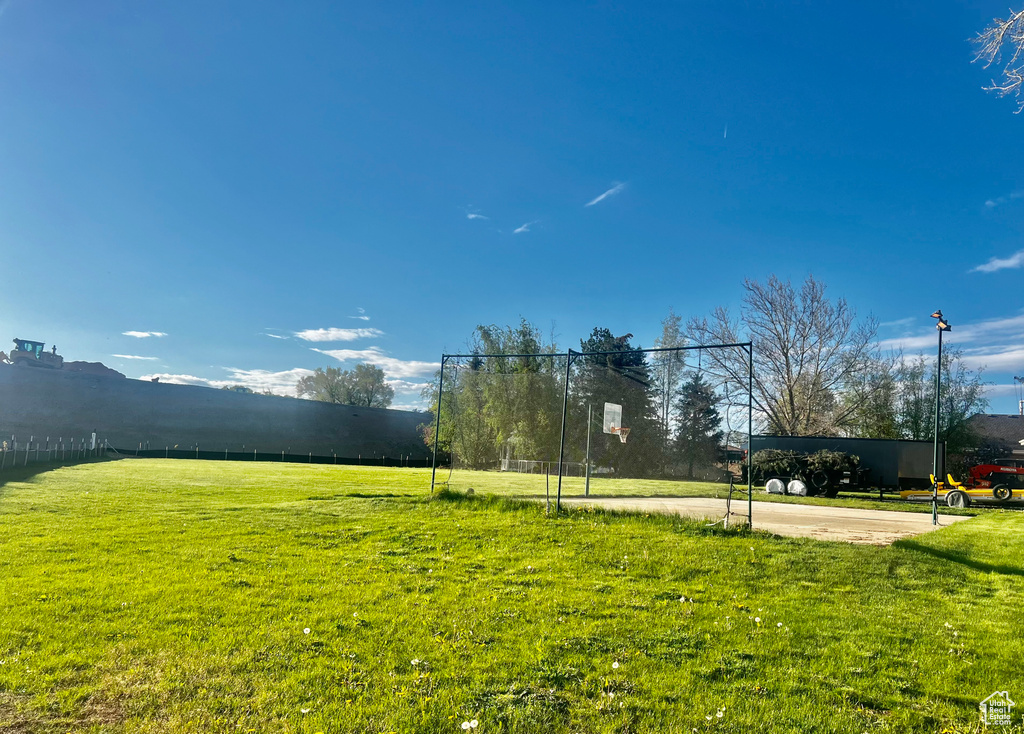 View of property's community with a yard and fence