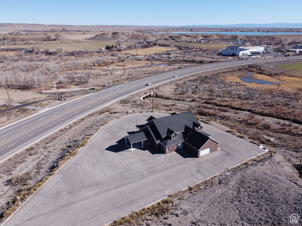 Aerial view of property and surrounding area with a mountainous background and a desert landscape