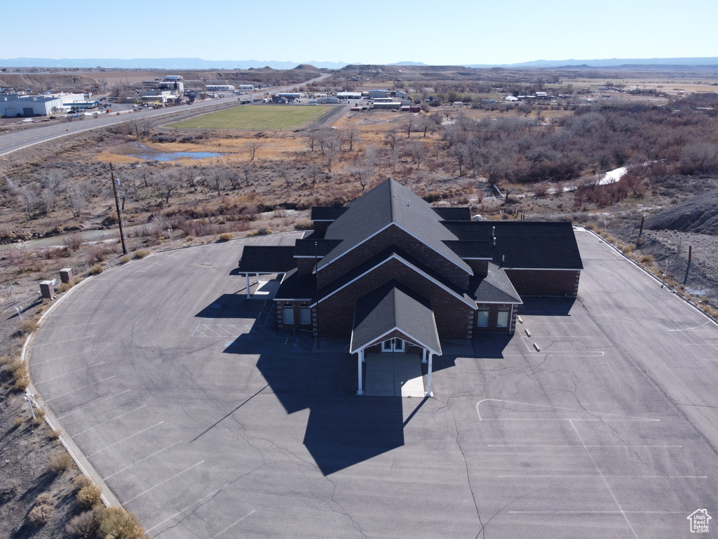Aerial view of property and surrounding area featuring a mountain backdrop