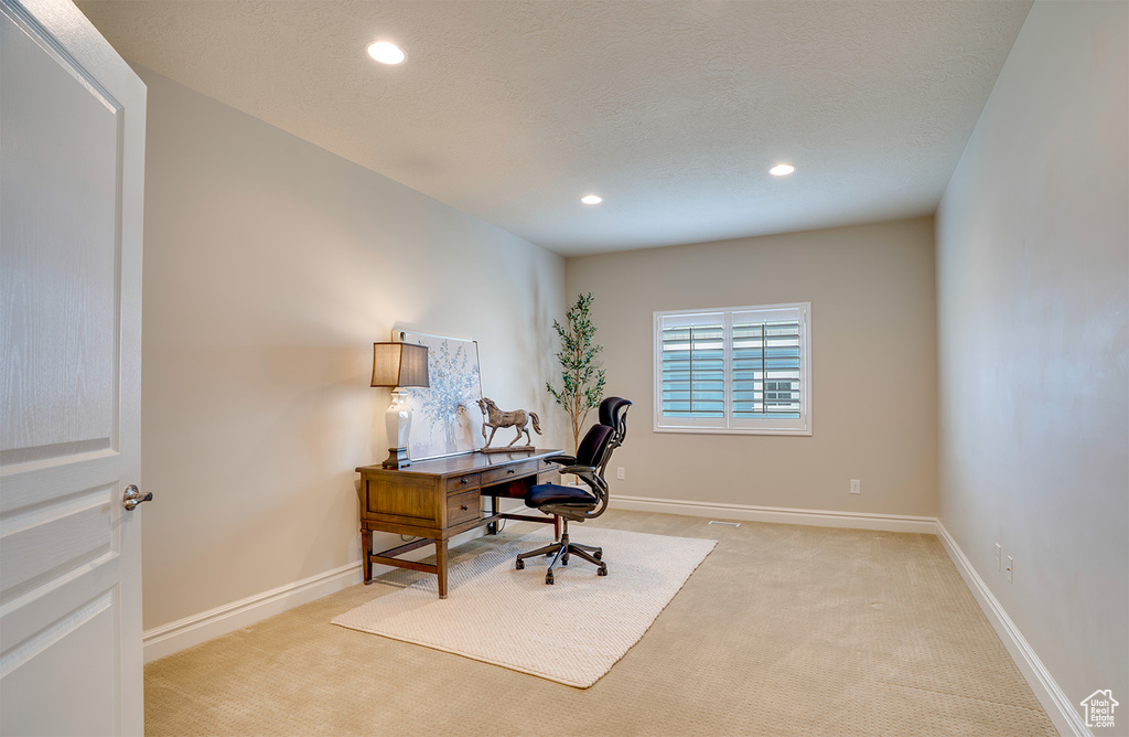 Home office with light colored carpet, baseboards, and recessed lighting