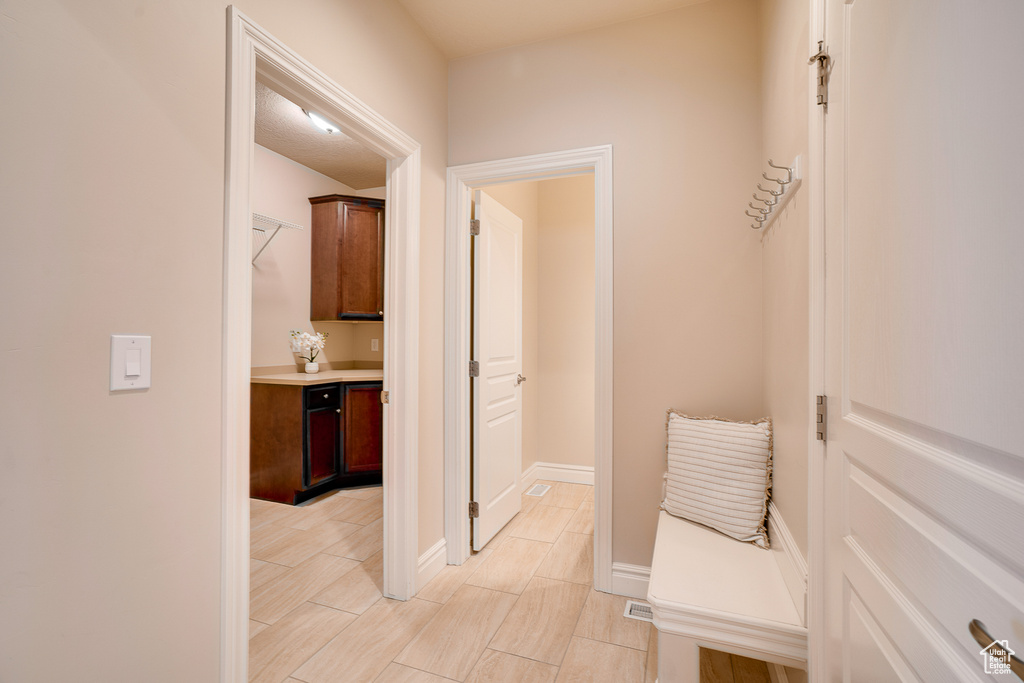 Corridor featuring baseboards