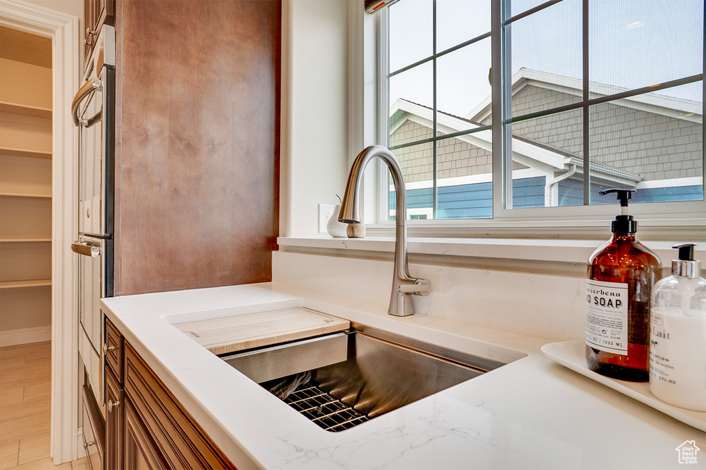 Details with brown cabinets, oven, and a sink