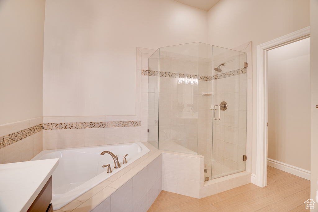 Bathroom featuring a garden tub and a stall shower