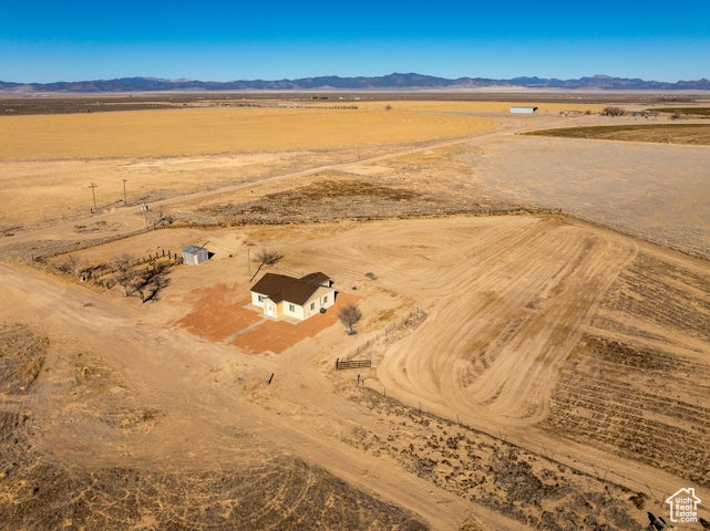 Aerial view of sparsely populated area featuring a mountainous background and a desert landscape