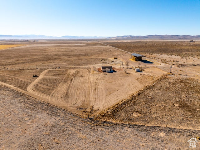 Aerial view of property's location featuring rural landscape, a desert landscape, and a mountainous background