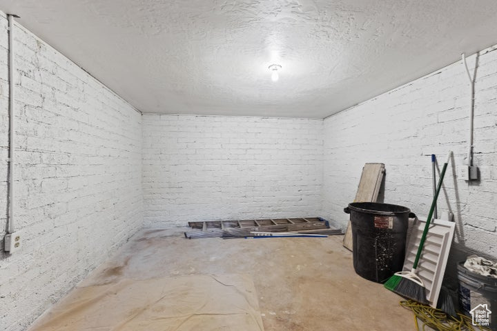 Finished below grade area with brick wall