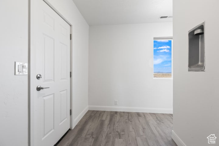Spare room with wood finished floors and baseboards