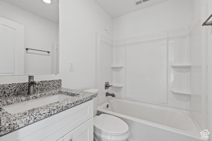 Full bath with toilet, bathtub / shower combination, and vanity