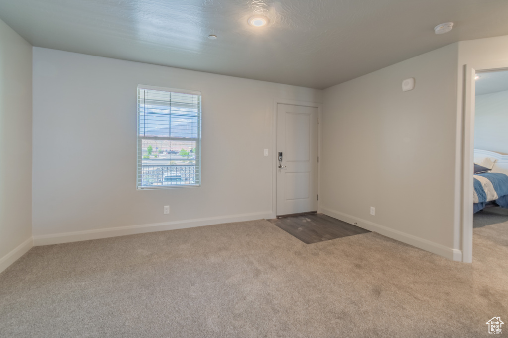 Entrance foyer featuring carpet flooring and baseboards