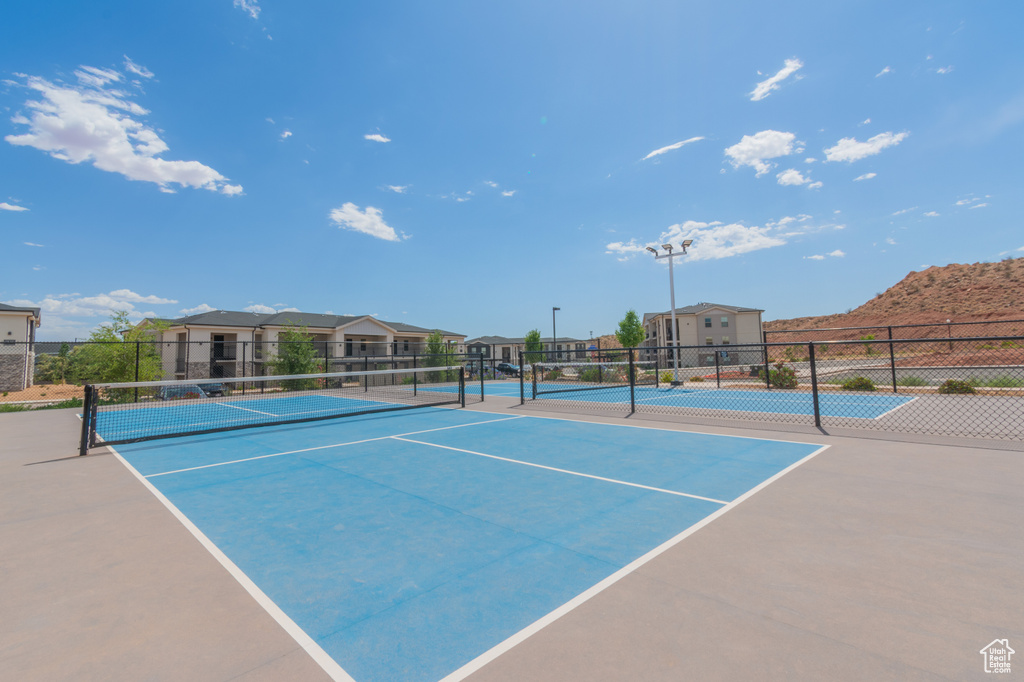 View of tennis court featuring a residential view