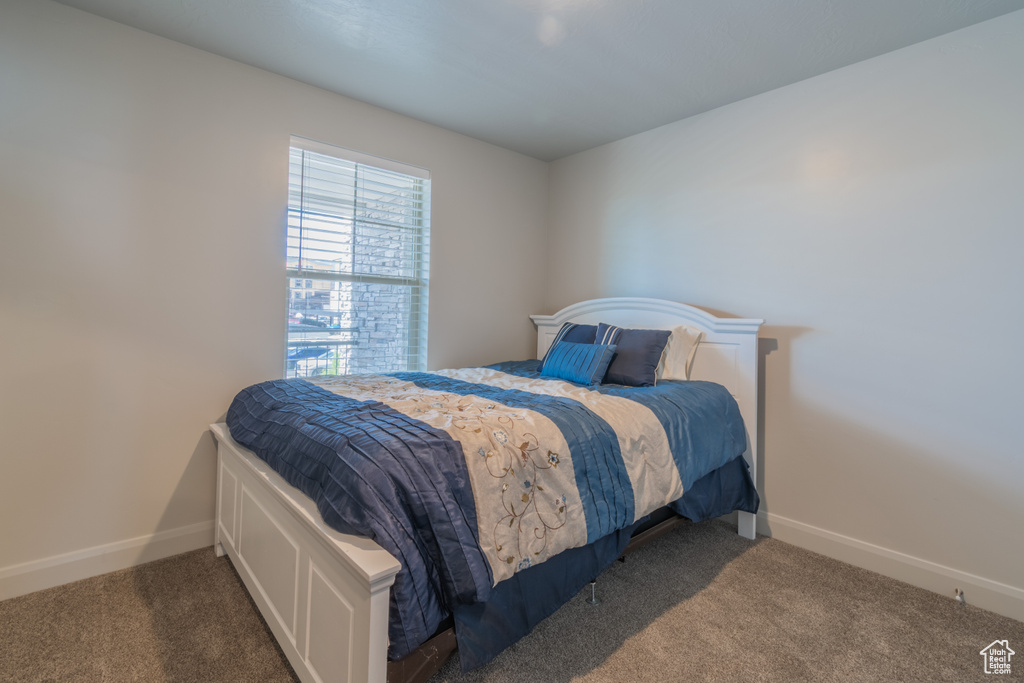 Carpeted bedroom with baseboards