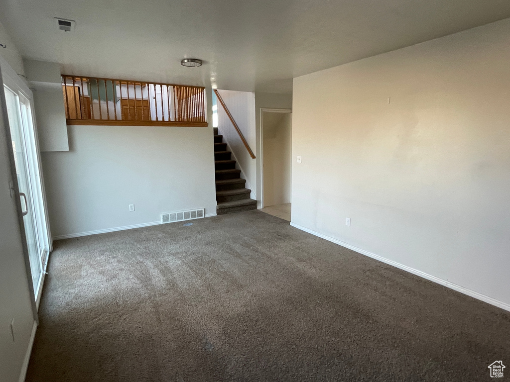 Unfurnished living room featuring carpet flooring