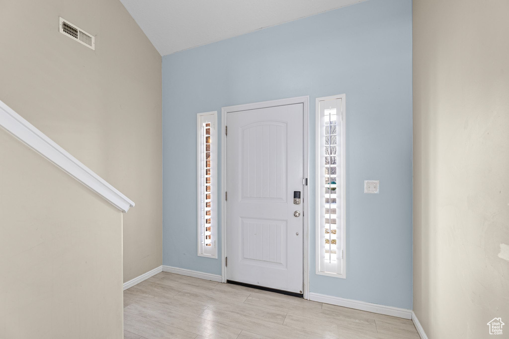 Foyer entrance with light hardwood / wood-style floors