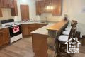 Kitchen featuring a breakfast bar area, range, and kitchen peninsula