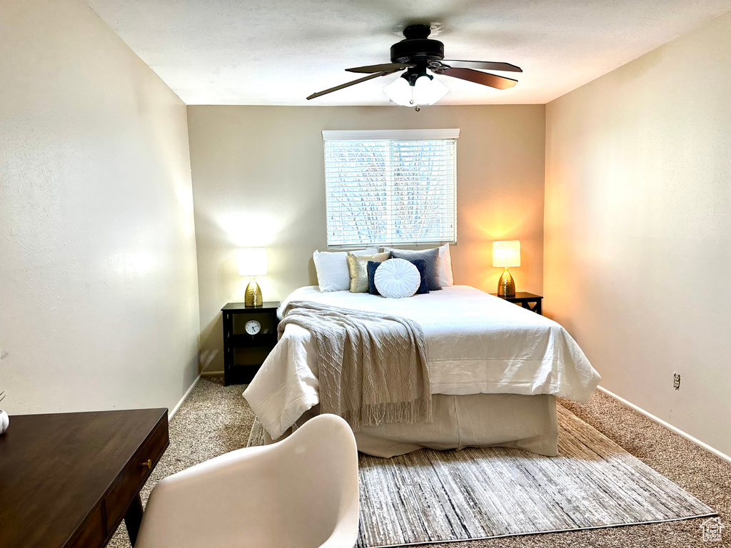 Carpeted bedroom with ceiling fan