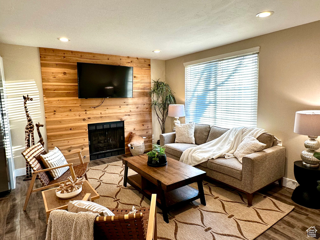 Living room with hardwood / wood-style flooring and wood walls