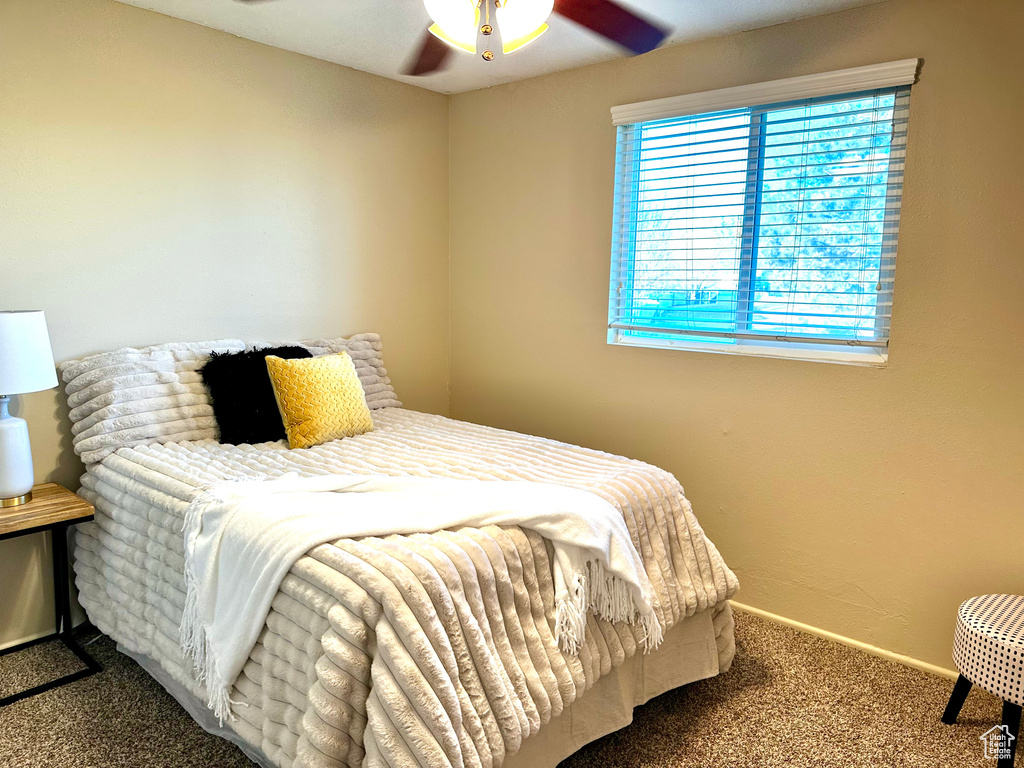 Bedroom with ceiling fan and carpet