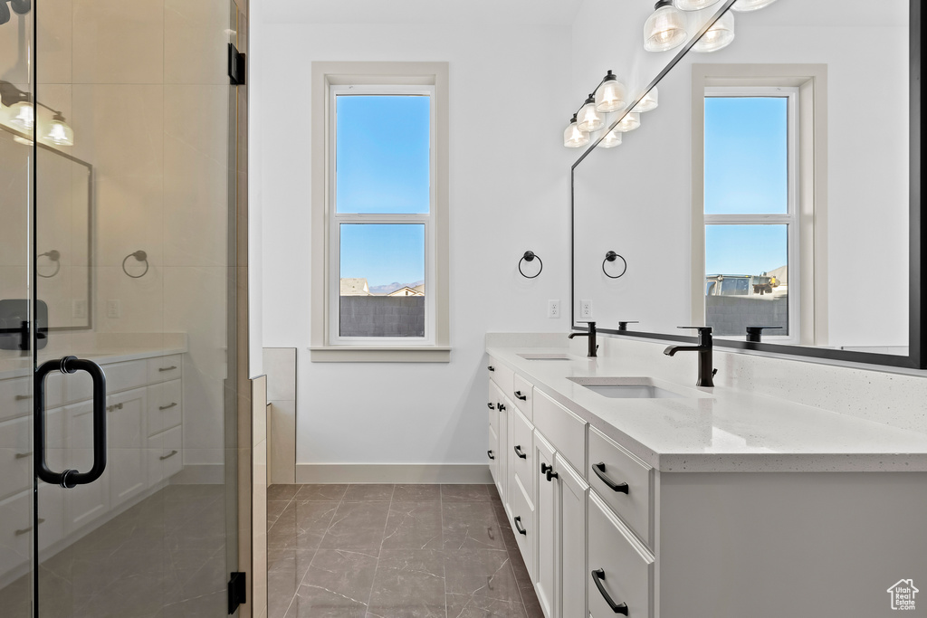 Bathroom featuring vanity and a shower with shower door