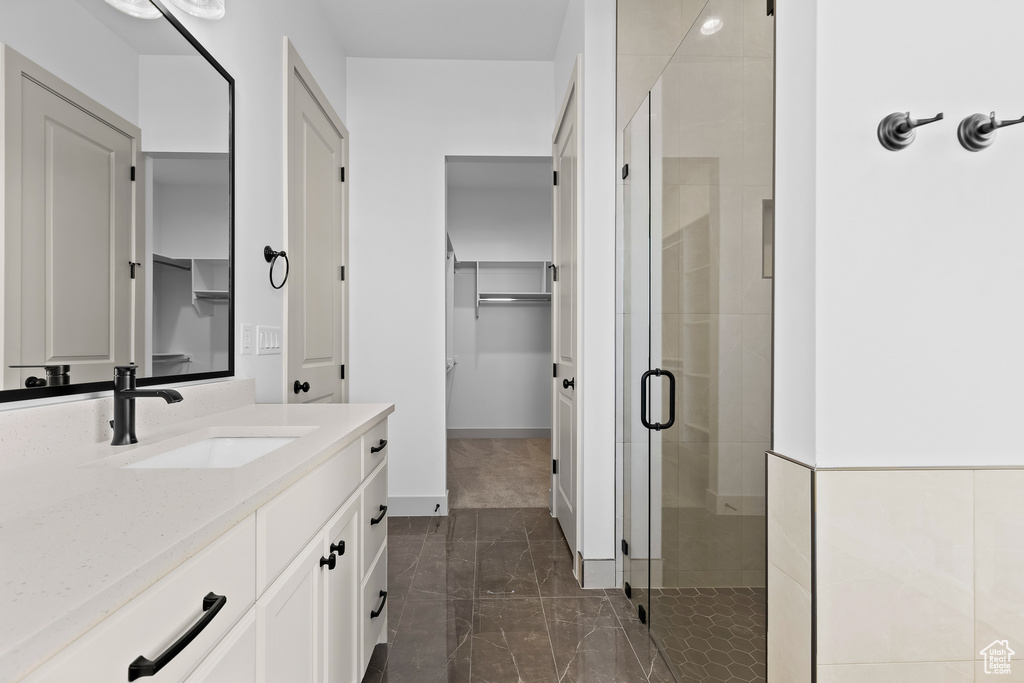 Bathroom with an enclosed shower and vanity