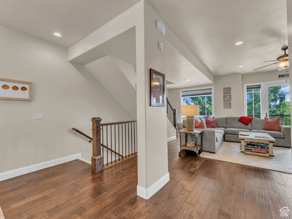 Living area featuring ceiling fan, wood-type flooring, baseboards, and recessed lighting