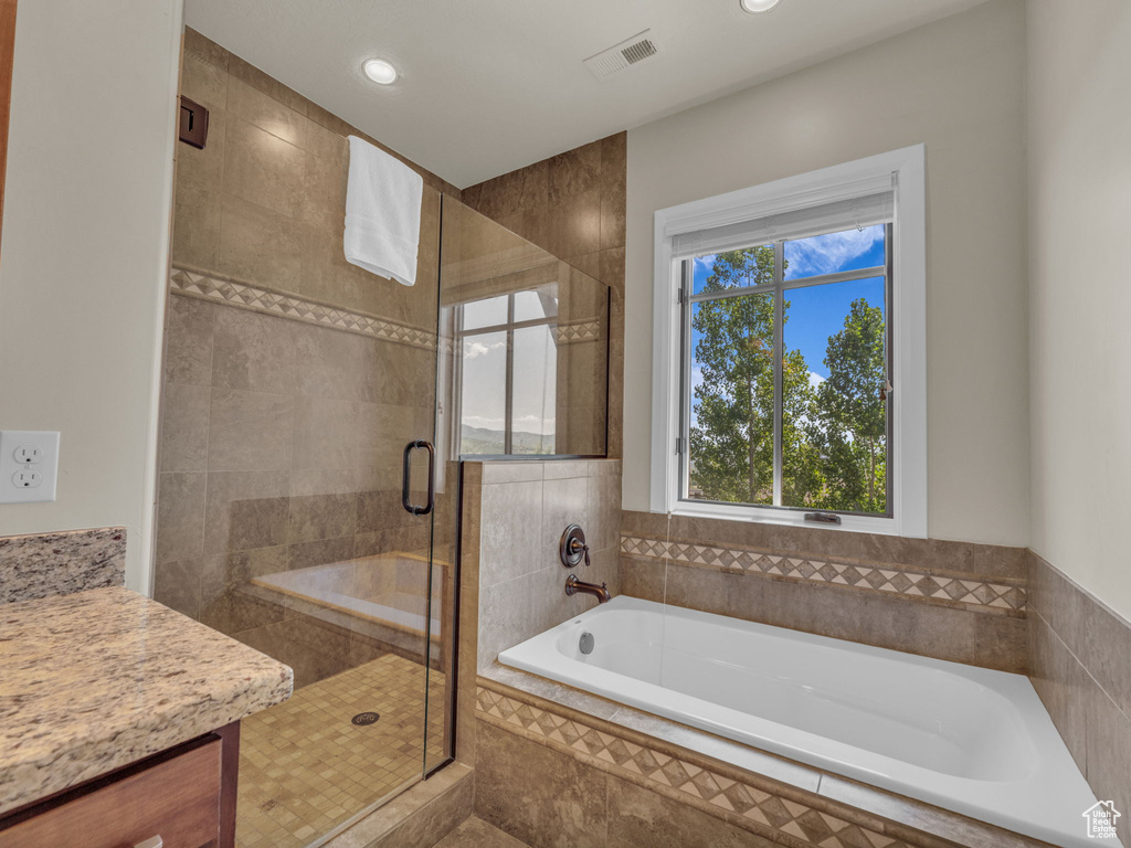 Full bath with a bath, a shower stall, recessed lighting, and vanity