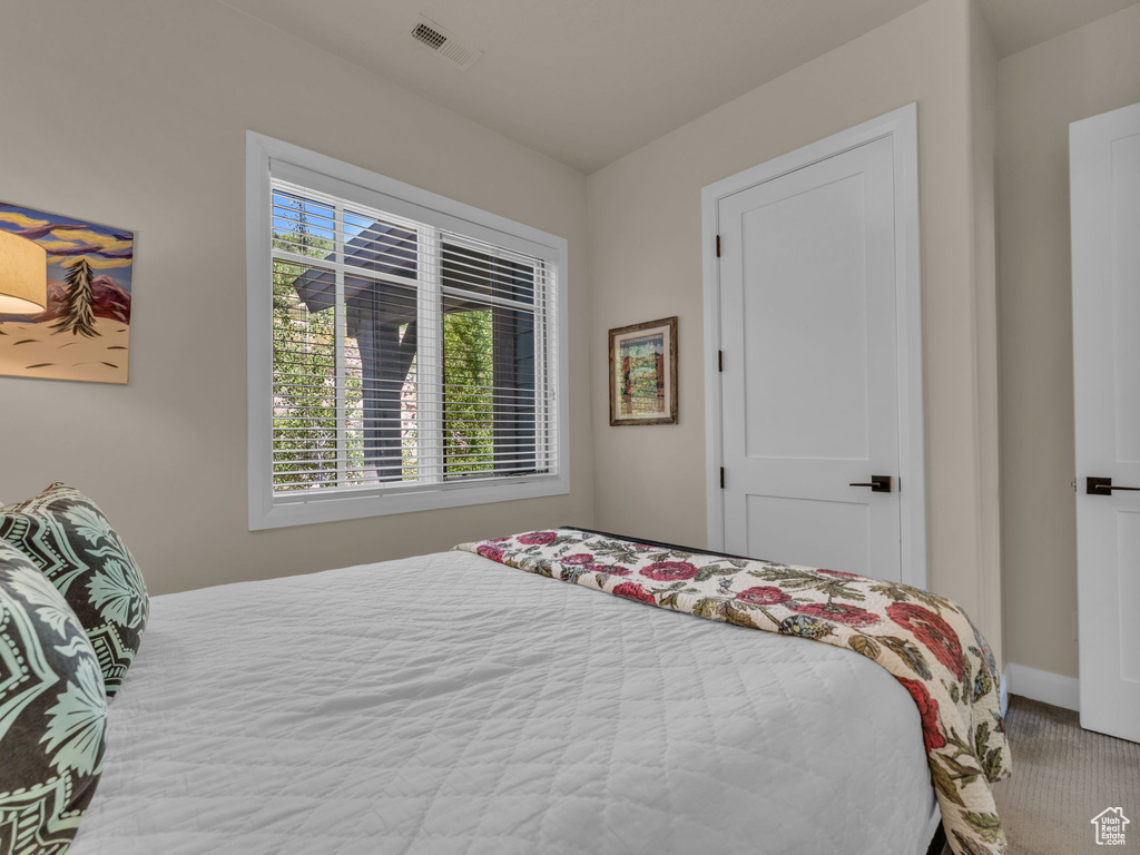 Bedroom featuring carpet and baseboards