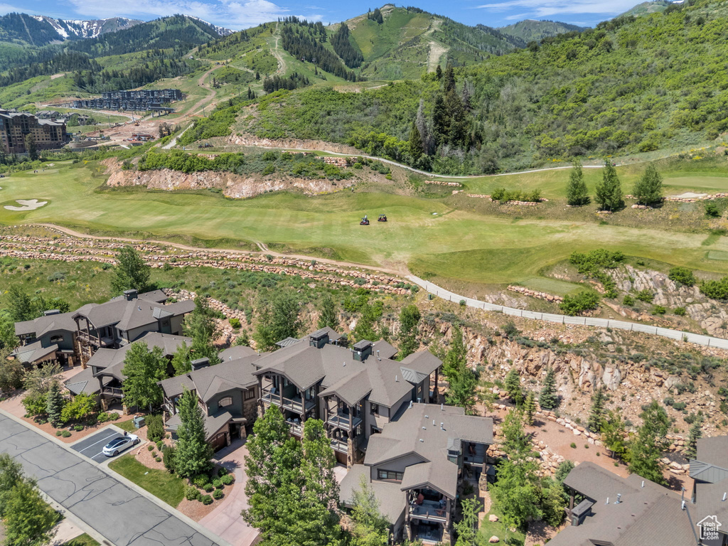 Aerial overview of property's location with mountains and a golf course