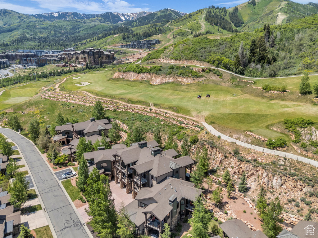 View of property location with a mountainous background and a golf course