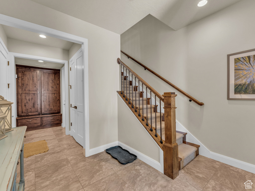 Staircase featuring baseboards and recessed lighting