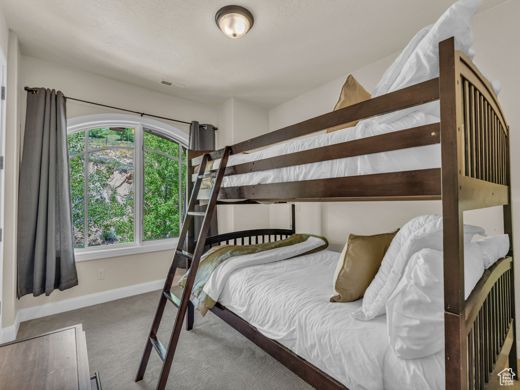 Bedroom with carpet floors and baseboards