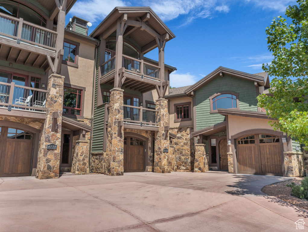 View of building exterior with driveway and a garage