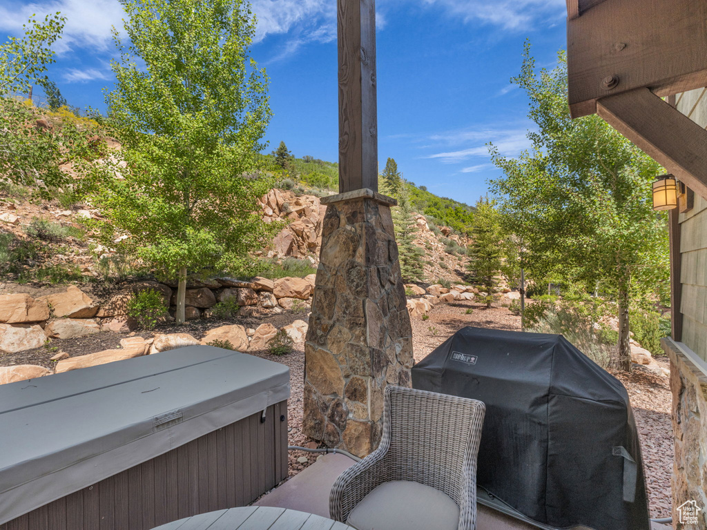 View of patio / terrace with area for grilling and a hot tub