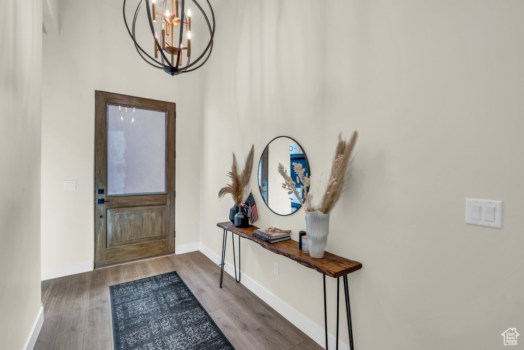 Entryway featuring an inviting chandelier and hardwood / wood-style floors