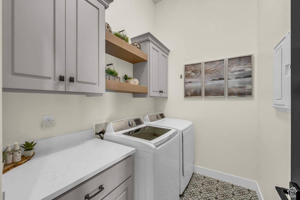 Laundry area with cabinets and washer and clothes dryer