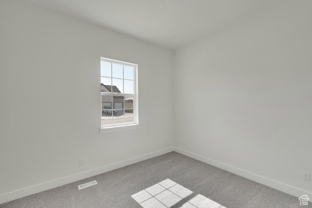 Unfurnished room featuring baseboards and carpet floors