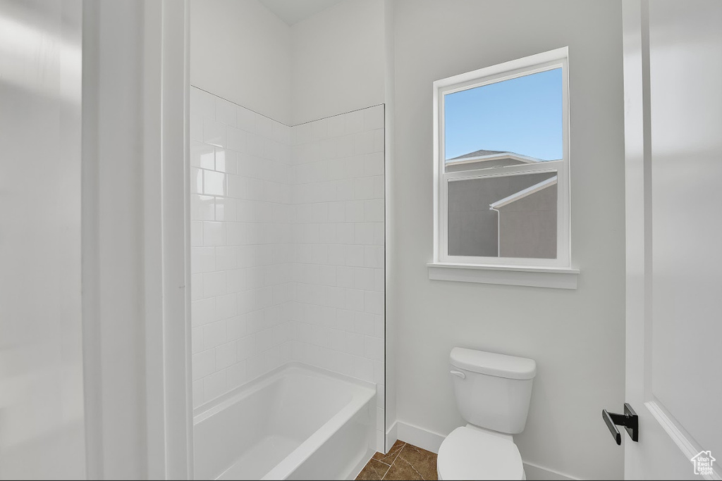 Full bath featuring toilet and bathtub / shower combination