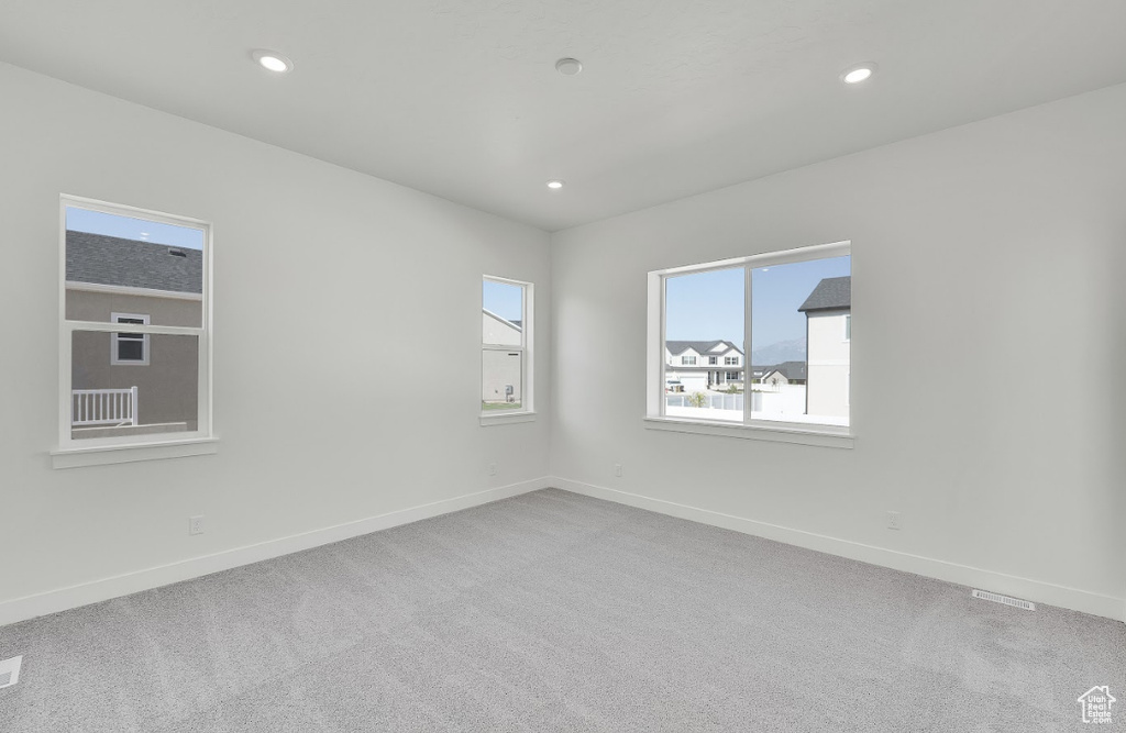 Spare room with carpet flooring and recessed lighting