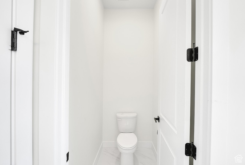 Bathroom with marble finish flooring and baseboards