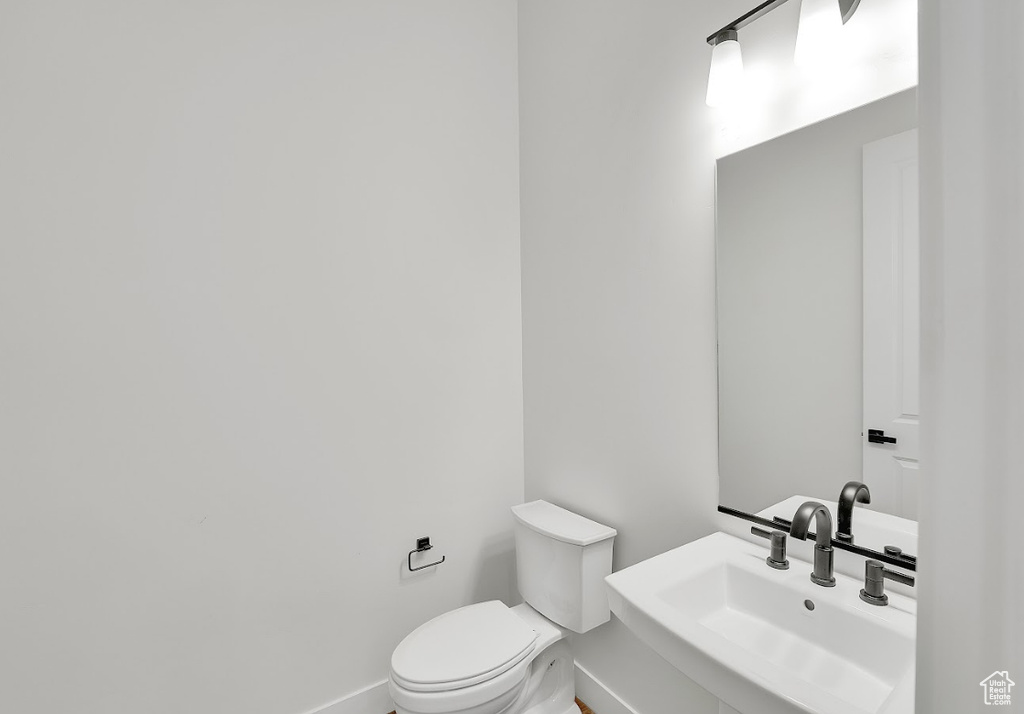 Bathroom featuring a sink and baseboards