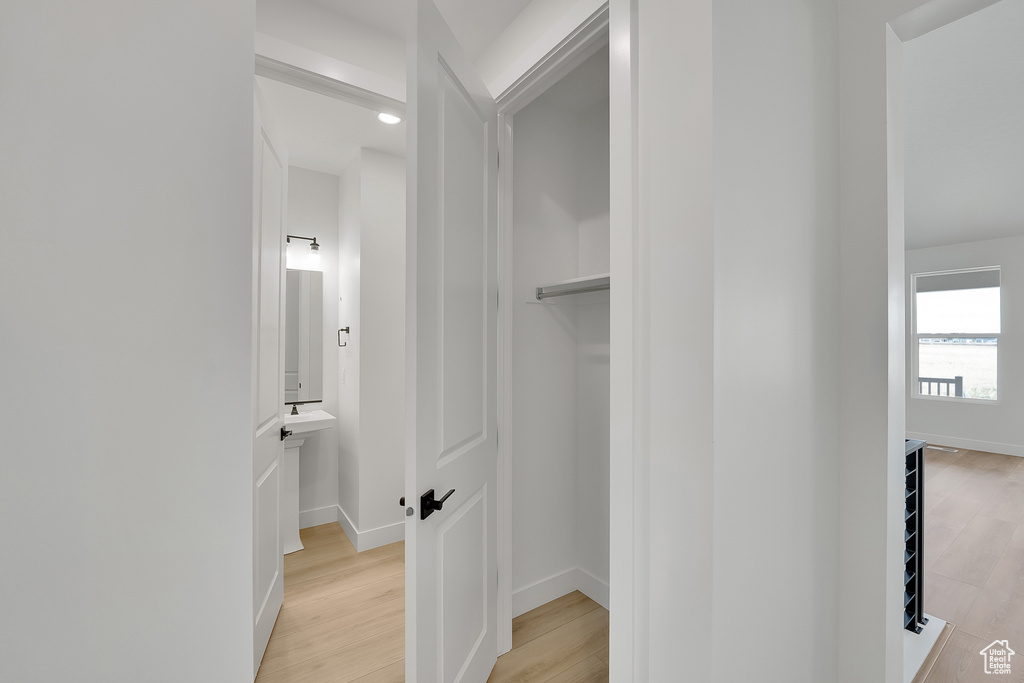 Hall featuring light wood finished floors and baseboards