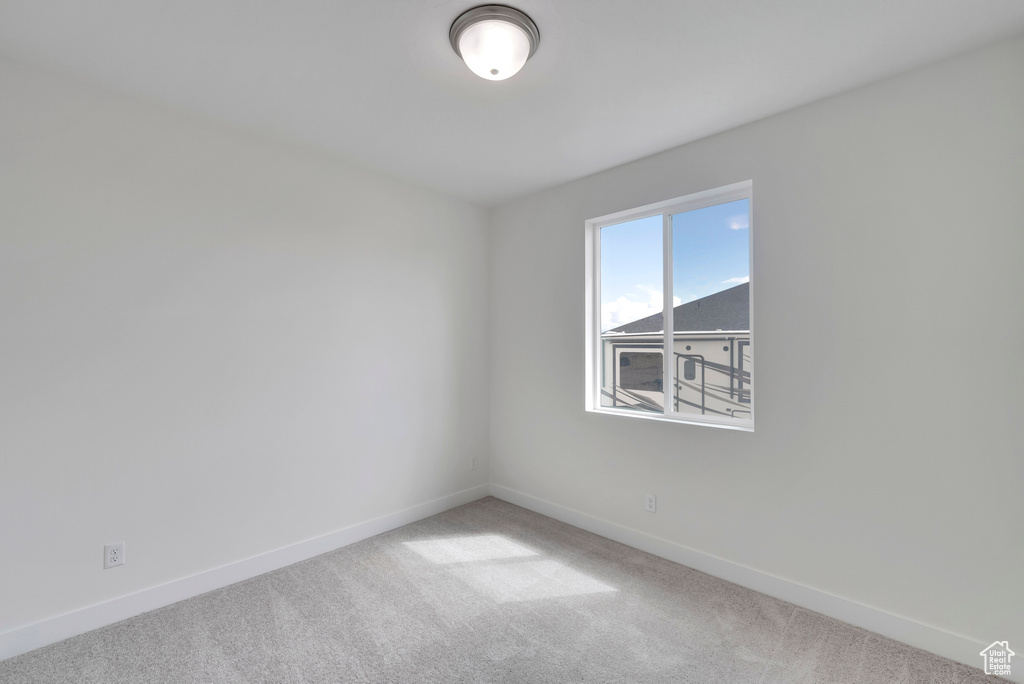 Unfurnished room featuring carpet floors and baseboards
