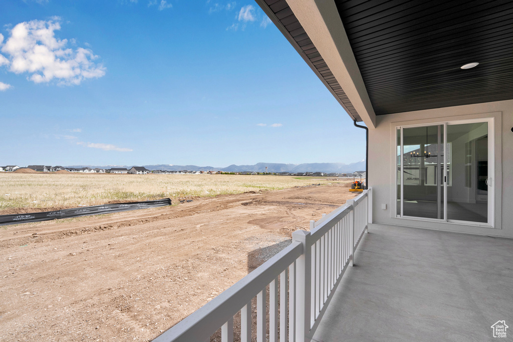 Balcony featuring a mountain view and a view of countryside