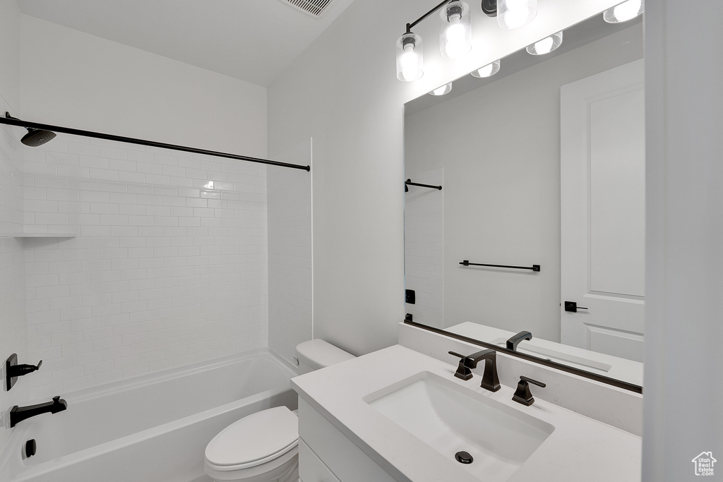 Full bathroom with toilet, vanity, and shower / bathtub combination