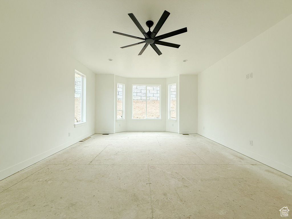 Unfurnished room featuring baseboards and ceiling fan