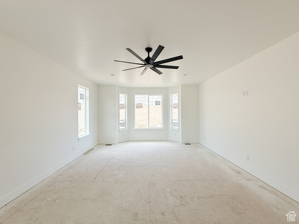 Spare room featuring baseboards and a ceiling fan